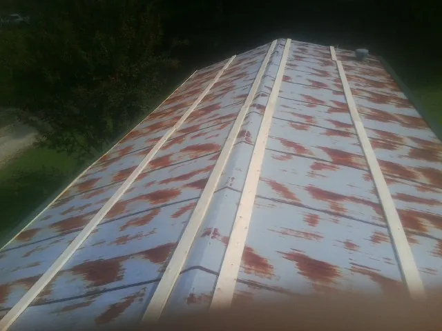 Rusted metal roof panels with new wood purlins before replacement — Storm Damage Roof Repair in Emigrant by Roofing Brothers